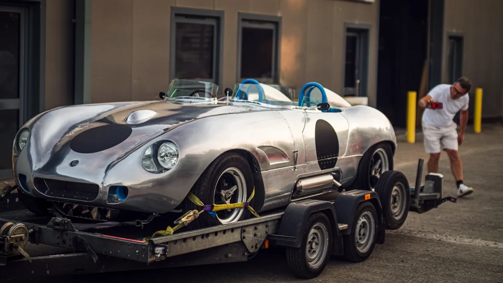 Sterling-Speedster-bespoke-classic-car-Forte-Vision-on-trailer-man-photographing car also